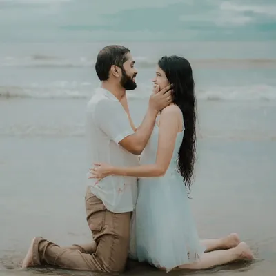 A tender moment on the sand, with the ocean as a witness. This intimate beach pre-wedding photo captures the deep affection between Pragati and Swapnil.