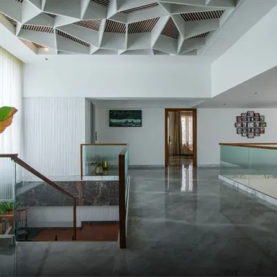 Where geometry meets elegance. This space features an intricate, geometric false ceiling that serves as a statement of art, depth, and craftsmanship.