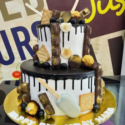 A 4kg two-tiered chocolate lover's dream, loaded with various chocolate bars, Ferrero Rocher, and even a cakesicle.
