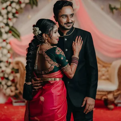 A beautiful couple photo, where the bride's custom green blouse with a detailed back design stands out.