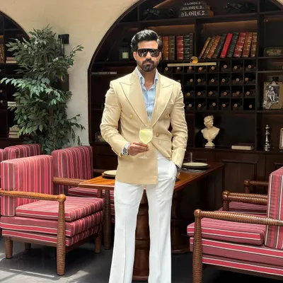 The full expression of our beige double-breasted suit. Paired with flared white trousers, this outfit exudes a retro-inspired elegance, showcasing a complete, head-to-toe bespoke look.