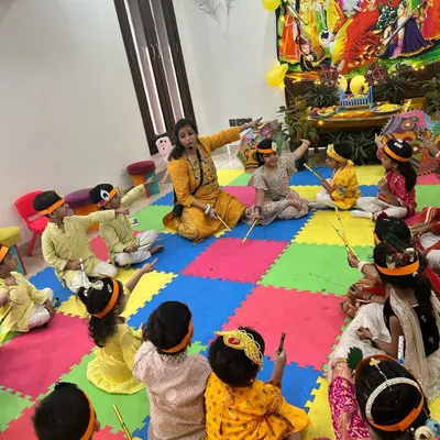 An interactive storytelling session during our Janmashtami celebration. The children, dressed in festive attire, are completely engaged as they learn about the story of Lord Krishna in a vibrant and colorful setting.