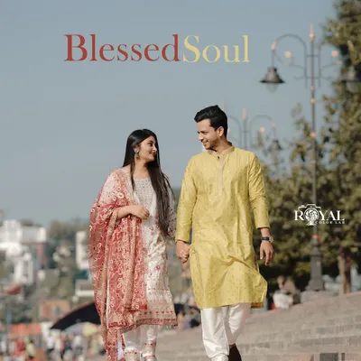 A beautiful, candid moment of a couple in traditional attire walking along the Rishikesh ghats, capturing the authentic local vibe.