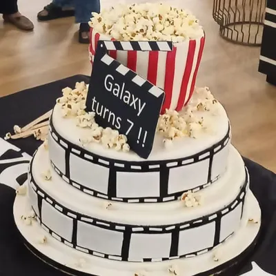 Another angle of the incredible cinema-themed cake for WeWork's anniversary. The details, from the film reel to the popcorn bucket, are all handcrafted and edible.