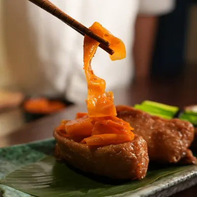 This is our Open Inari Zushi from the spring Sakura menu. Sweet and savory tofu pouches are filled with seasoned rice and topped with beautiful garnishes, celebrating the flavors of the season.