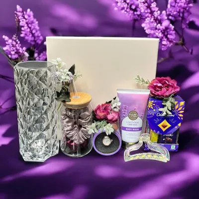 A lovely lavender-themed hamper perfect for a sister or friend. This gift set includes a crystal-cut vase, a jar of scrunchies, lavender body wash, chocolates, and other matching accessories.