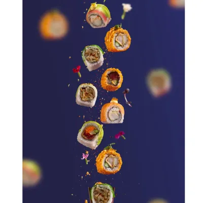 A creative levitation shot I styled for Harajuku Tokyo Cafe. This dynamic image captures a variety of sushi rolls mid-air, showcasing their color and texture.