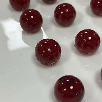 These are our Cranberry Caramelised Pearls, a specialty confection made with real fruit and no added colours or flavours. Their glossy finish and natural taste make them a beautiful and delicious inclusion for desserts and pastries.