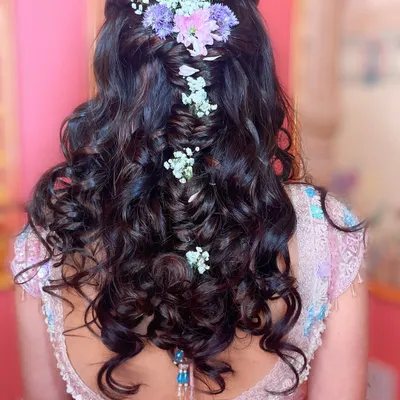 A fairytale hairstyle for a fairytale bride. I created this intricate braided look with soft curls and fresh pastel flowers for an engagement ceremony.