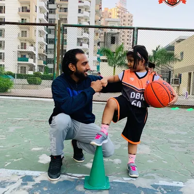 It's more than just coaching; it's about mentorship. Here I am sharing a moment of encouragement with one of our youngest players during a drill.