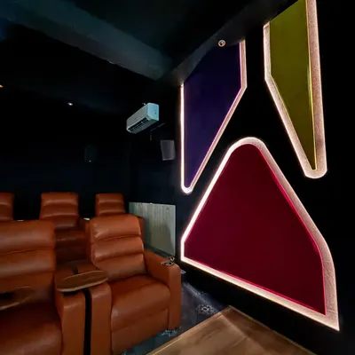 This dedicated cinema room features custom acoustic wall panels with integrated lighting, which not only look great but also fine tune the room's sound. The comfortable leather recliners are perfectly positioned for the best viewing and listening experience.