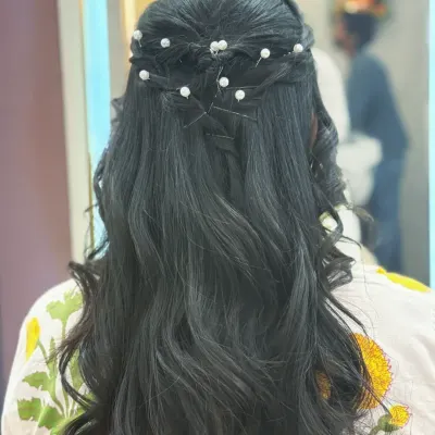 An elegant half-up hairstyle with intricate twists and pearl accessories. This is a perfect look for weddings, parties, or any formal event where you want to look polished.