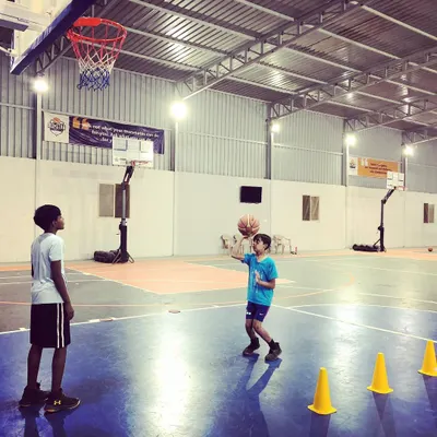 Building a strong foundation is key. Here, a young player works on shooting mechanics with cones for guidance, a common sight during our coaching sessions.