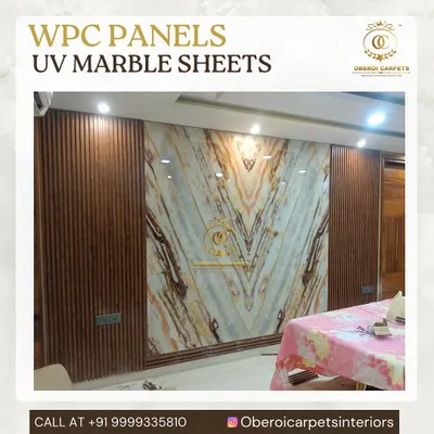 This stunning feature wall combines the warmth of wood-grain WPC panels with the elegance of a book-matched UV marble sheet. The V-pattern of the marble creates a dynamic and luxurious focal point in the dining area.