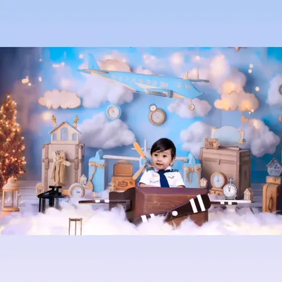 Our little pilot theme is perfect for adventurous spirits. This wide shot shows the complete setup with clouds, airplanes, and vintage travel props.
