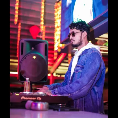 Focused on the mix, blending tracks at the Pioneer console. This is where the art of DJing happens.