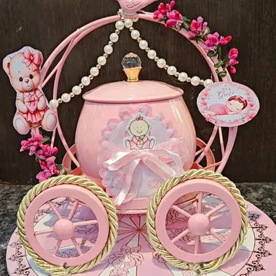 This beautiful pink carriage is my signature hamper for welcoming a baby girl. It’s an elaborate and memorable gift that can be filled with chocolates, baby essentials, and other custom treats for the new parents.