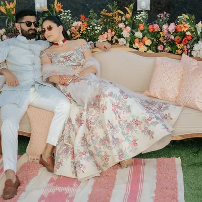 For a 'Nazar Na Lage' themed welcome lunch in Jaipur, the couple relaxes against a backdrop of vibrant, fresh flowers. The setting blends royal Rajasthani charm with relaxed, modern elegance.