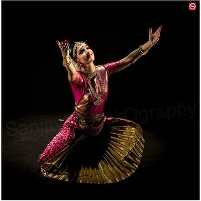 A moment of complete surrender and devotion during a solo Bharatanatyam performance. The dramatic lighting by photographer Sanjay Kaul highlights the sculptural quality of the pose.