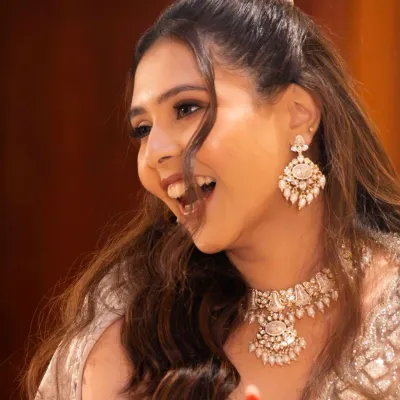 A laugh that lights up the room. For her sangeet, we created a look that was effortless and natural, allowing her joyful spirit to be the main focus. The makeup was designed to last through every smile and dance move.