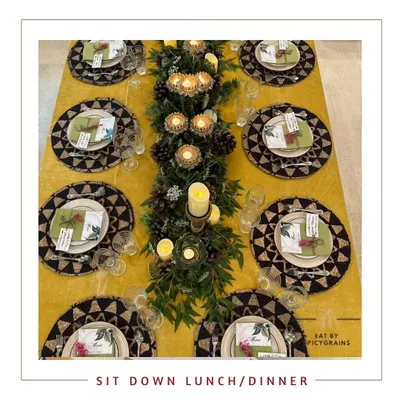 An overhead view of our elegant sit-down dinner setup. The table is beautifully styled with custom placemats, a lush centerpiece, and ambient candlelight for a truly luxurious experience.