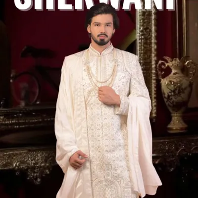 This is our classic ivory white sherwani, a timeless choice for any groom. We focus on intricate embroidery and a majestic fit, ensuring you look nothing less than royalty on your wedding day. We can customize the fabric and detailing just for you.