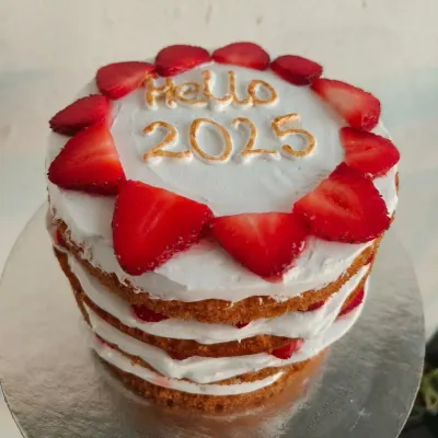 A fresh strawberry cream cake to welcome the new year. This naked-style cake shows off the beautiful layers of sponge, cream, and fresh fruit.