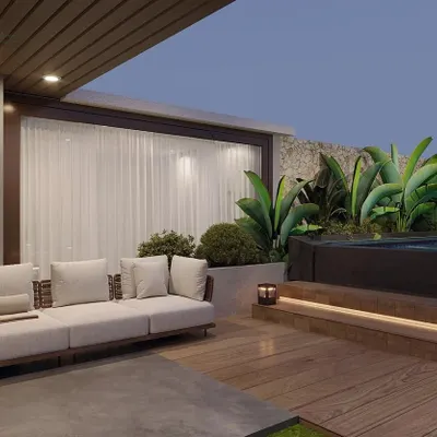 A view of the Gurugram terrace project, showing the comfortable lounge seating next to the elevated pool deck. The design ensures a smooth transition from the indoor space to the outdoor lounge.