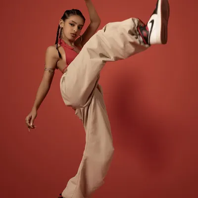 A favorite shot from a recent photoshoot. This dynamic kick pose captures the power and energy I strive for in my dancing, set against a bold red background.