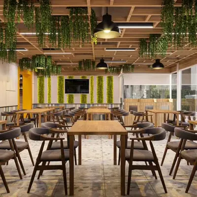 This cafe interior showcases our expertise in biophilic design, incorporating abundant greenery and natural wood to create a fresh and calming atmosphere. The layout is optimized for customer flow, with a mix of seating arrangements to accommodate different group sizes.