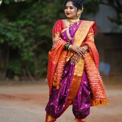 A majestic Maharashtrian bride in a traditional Peshwai Nauvari saree. I specialize in the intricate draping of this nine-yard wonder and pair it with bold makeup, a classic nath, and a crescent bindi to complete the royal look.