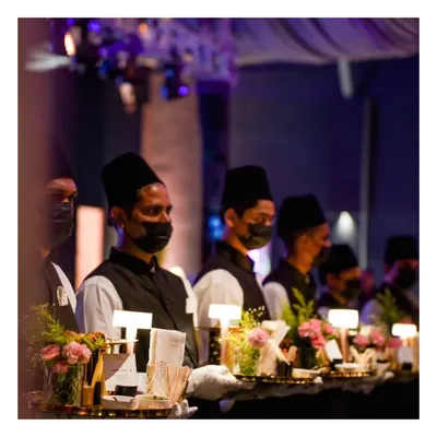 A line of our service staff, uniformly dressed and ready for a grand engagement event, symbolizing our commitment to organized and impeccable service.