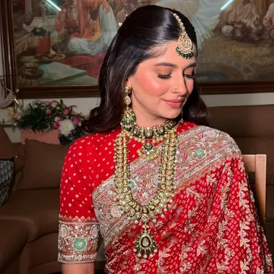 A beautiful close-up of a bride's soft and radiant makeup. The look features defined eyes, a natural glowing base, and a neutral lip color, perfect for a traditional wedding ceremony.