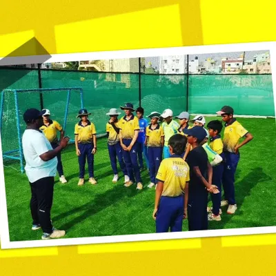 A group of young players getting instructions from a coach during our summer camp. Our camps are designed to be fun, engaging, and highly educational.