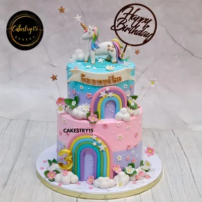 A magical two-tier unicorn cake in a beautiful pastel palette. This choco-vanilla cake is adorned with a handcrafted unicorn, fondant rainbows, fluffy clouds, and delicate flowers for a dreamy birthday celebration.