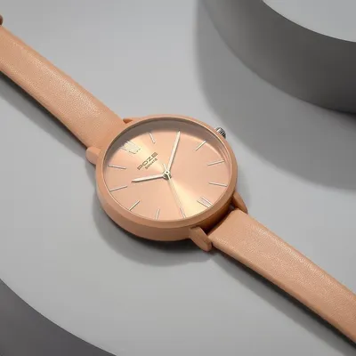 Product styling for a Sonata watch in a soft blush tone. I used curved, neutral-colored props to create a gentle, minimalist background that complements the watch's feminine design and color.