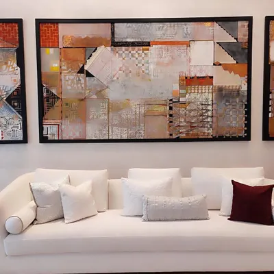 Timeless in white, this sofa embodies quiet luxury and tranquility. Paired with a curated selection of our textured white and deep burgundy cushions, it becomes the serene centerpiece of a sophisticated living space, anchored by compelling modern art.