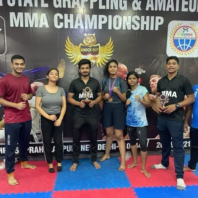 A group photo of Team Knockout after a grappling and amateur MMA championship. We are a diverse team of men and women who support each other.