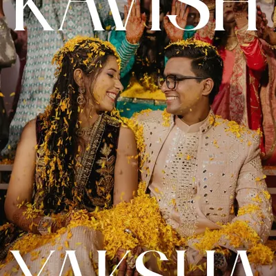 The quintessential Haldi moment. Covered in flower petals, the couple shares a look of pure happiness. This image captures the vibrant, joyful, and slightly chaotic spirit of the ceremony that we love.