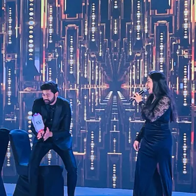On stage during a Sangeet, engaging with the groom and getting the crowd laughing. My role as an entertainer is to create these spontaneous, fun-filled interactions that become the highlights of the evening.