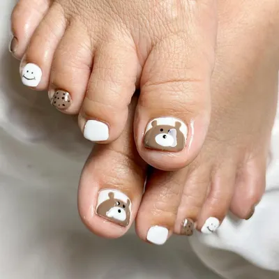 Your toes deserve to be cute too. This adorable pedicure features hand-painted bears, cookies, and smiley faces.