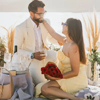 A beautiful moment captured during a celebration. My client wears a bespoke off-white suit, tailored to perfection for this romantic seaside picnic.
