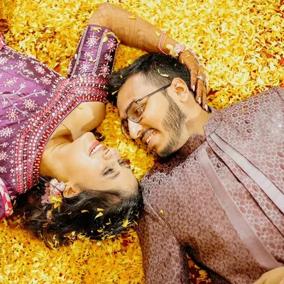 Lying in a bed of flowers, lost in their own world. This is one of my favorite ways to shoot a 'phoolon ki haldi', creating a romantic and dreamy portrait amidst the fun.