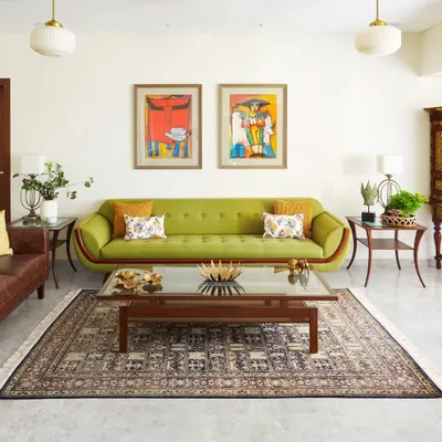 This living room is one of my favorite projects, where vibrant colors and vintage-inspired furniture come together. The green sofa, bold artwork, and classic Indian rug create a space that is full of personality and warmth.