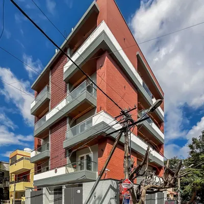 An angular view of the 'Vihaan' apartment building, showing how the design engages with its corner plot in HSR Layout.
