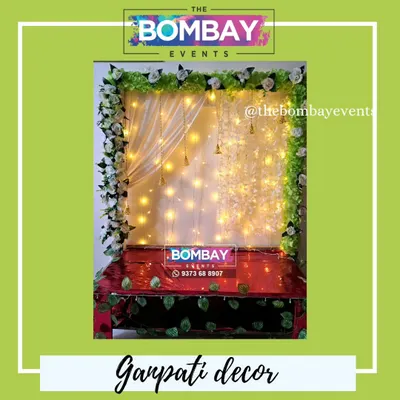 A simple yet elegant home setup for Ganpati. We used a green foliage backdrop decorated with white flowers and warm fairy lights to create a divine space for Bappa.