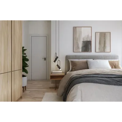 This minimalist bedroom features a floor-to-ceiling wardrobe with a light wood finish and handleless doors. The design blends seamlessly with the wall, creating a clean, modern look while providing extensive storage.