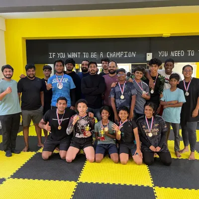 Our team celebrating together after an in-house tournament. This picture captures our spirit perfectly: a diverse group of kids and adults, proud of their efforts and happy for each other's success.