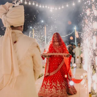 The bride's breathtaking entrance, walking towards the groom through a path of sparklers. This is a moment of pure magic and anticipation.