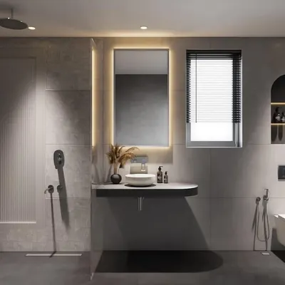 For this project, we combined two small bathrooms to create one spacious master bathroom. The design uses a grey color scheme with a mix of textures, shapes, and a backlit mirror to create a warm and versatile space.
